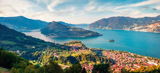 Aerial summer view of Iseo lake. Splendid morning cityscape of Marone town with Monte Isola island, Province of Brescia, Italy, Europe. Traveling concept background.