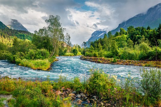 Picturesque summer view of Loelva river, located near Loen village, municipality of Stryn, Sogn og Fjordane county, Norway. Colorful sunny scene in Norway. Beauty of nature concept background.