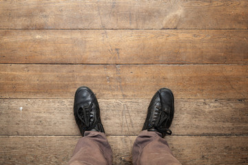 Male feet in shiny black leather shoes