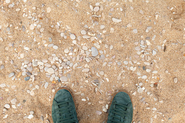 Male feet in green sporty suede shoes