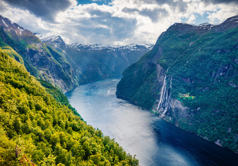 Fototapeta na wymiar Dramatic summer scene of Sunnylvsfjorden fjord, Geiranger village location, western Norway. Beautiful morning view of famous Seven Sisters waterfalls. Beauty of nature concept background.