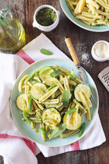 Italian penne pasta with roasted zucchini, pesto sauce and green beans