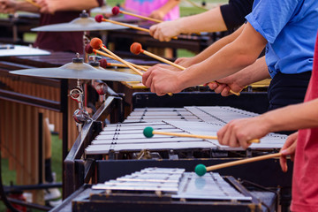 flashing mallets of the sideline percussionists at rehearsall