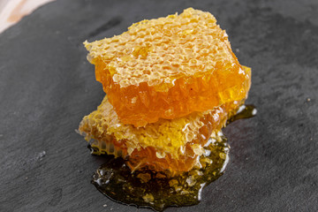 Slide sweet honeycombs on a stone board, organic product