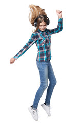 Teen girl in checkered shirt dancing listening music in headphones