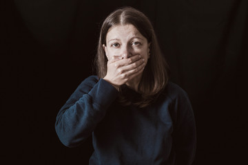 Woman with hands closed mouth. Female violence concept. Restriction and inability to speak.