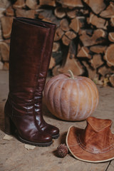 Leather hat and high boots stand on veranda