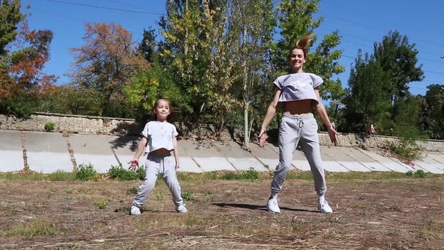 mom and daughter do sports outdoors