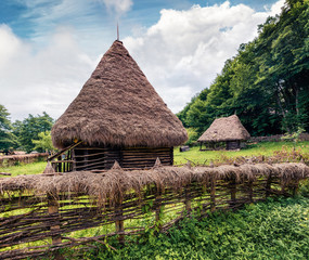 Stunning summer view of traditional romanian peasant houses. Wonderful rural scene of Transylvania, Romania, Europe. Beauty of countryside concept background.