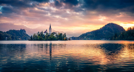 Dramatic morning view of Pilgrimage Church of the Assumption of Maria. Fantastic autumn scene of Bled lake, Julian Alps, Slovenia, Europe. Traveling concept background..