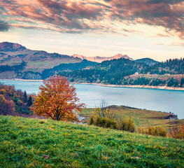 Wonderful morning view of Roselend lake/Lac de Roselend. Exciting autumn scene of Auvergne-Rhone-Alpes, France, Europe. Beauty of nature concept background.