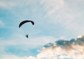 silhouette of skydiver with parachute - live your dream, freedom and adrenaline concept