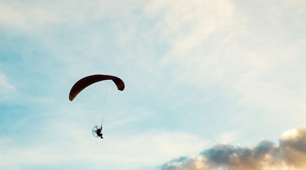 silhouette of skydiver with parachute - live your dream, freedom and adrenaline concept