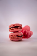 Fototapeta na wymiar Starwberry flavoured Macaroons with pink paper flower