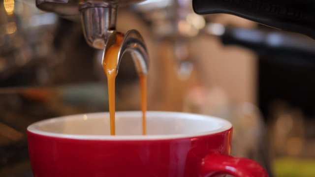Barista girl makes coffee cup on espresso machine in a cafe bistro at the morning