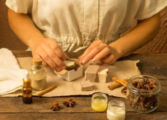 Woman hands wrap natural handmade soap with cocoa and cinnamon