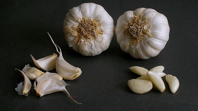 Shot of whole garlic bulbs and a few cloves of garlic. 