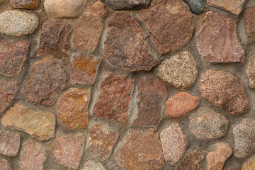 Close-up of granite cobblestone underpoured with concrete