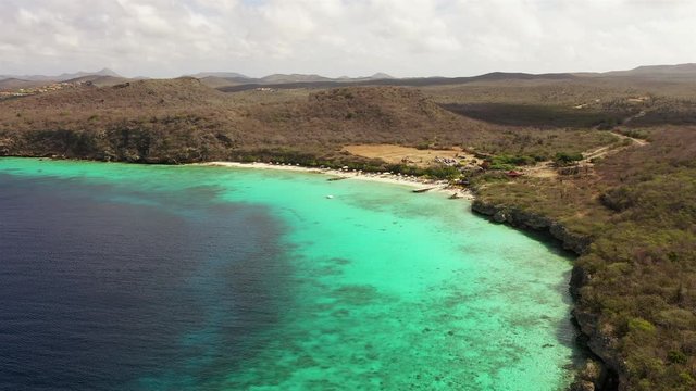 Aerial view of coast of Curaçao in the Caribbean Sea with turquoise water, cliff, beach and beautiful coral reef around Playa Porto Mari
