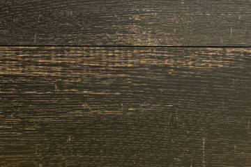 Flatlay of wooden black rough surface with scuffs