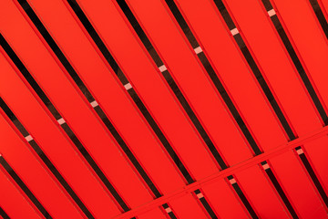 Corrugated orange metal profile surface (corrugated metal siding, profiled sheeting) background.
