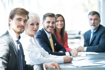 Business people sitting in a row and working