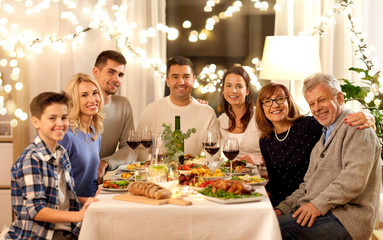 celebration, holidays and people concept - happy family having dinner party at home