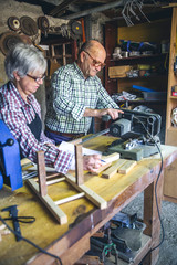 Senior couple working in a carpentry workshop