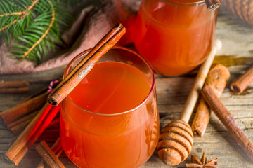 Winter and Christmas alcohol drink, Wassail hot cocktail with spices, wooden background copy space