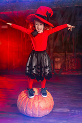 funny girl standing on a pumpkin