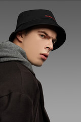 Close-up portrait portrait shot of a short-haired European man dressed in a gray hooded top, a...