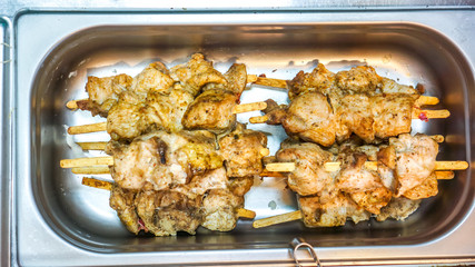 Barbecued chicken named yakitori. japanese food in metal plate. street food