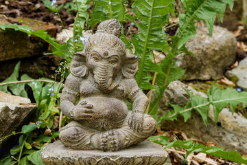 Fototapeta na wymiar Lord Ganesh stone figure in a garden