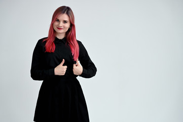 Naklejka premium Portrait of a pretty student girl with colored hair in a black suit on a white background in studio.