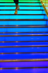 Steps on a colorful rainbow lit stairway