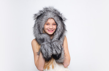 Happy child smile in fashion style. Small girl wear winter hat scarf. Small fashionista. Happy child smile in fashion style. Winter fashion trends for kids. Tips for caring for fur garments