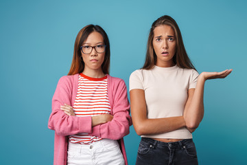 Portrait of multinational unhappy women posing and looking at camera