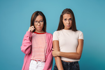 Portrait of multinational upset women looking at camera and crying