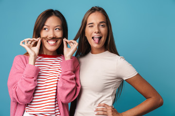Portrait of multinational cheerful women making fun and grimacing