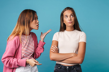 Portrait of multinational angry women having quarrel and shouting