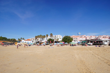Tourists diving and walking on Vau beach in Portimão, Algarve, Portugal - October 03, 2019.