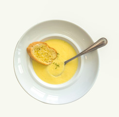 pumpkin soup with butter bread on white background