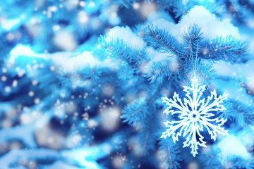The Christmas tree is covered with a layer of fluffy snow. Winter christmas background. Snowflakes in the soft white snow. Winter background.