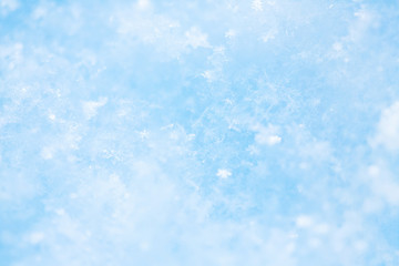 Winter christmas background. Snowflakes in the soft white snow. Winter background.