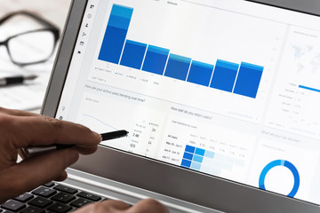 Krynica-Zdroj, Poland - July 11, 2017: Businessman using Google Analytics in the office on the touch screen of his tablet. Google Analytics is the most famous application for web traffic analysis.