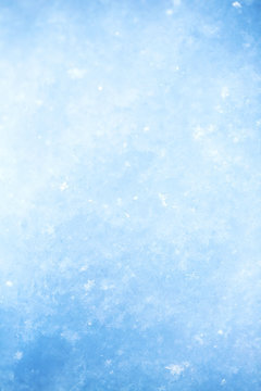 Winter christmas background. Snowflakes in the soft white snow. Winter background.