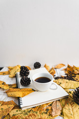 Yellow leaves on white and autumn and a cup of coffee