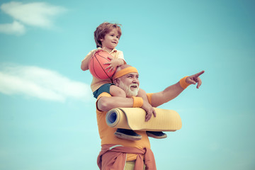Grandfather and child do morning exercise. Senior man workout in rehabilitation center. Healthy and...