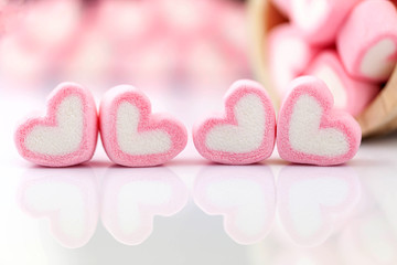 Pink marshmallow in heart shape  on  table with copy space.  Pastel color dessert for background or...