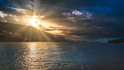 Dramatic sunrise with the sun beams over the sea